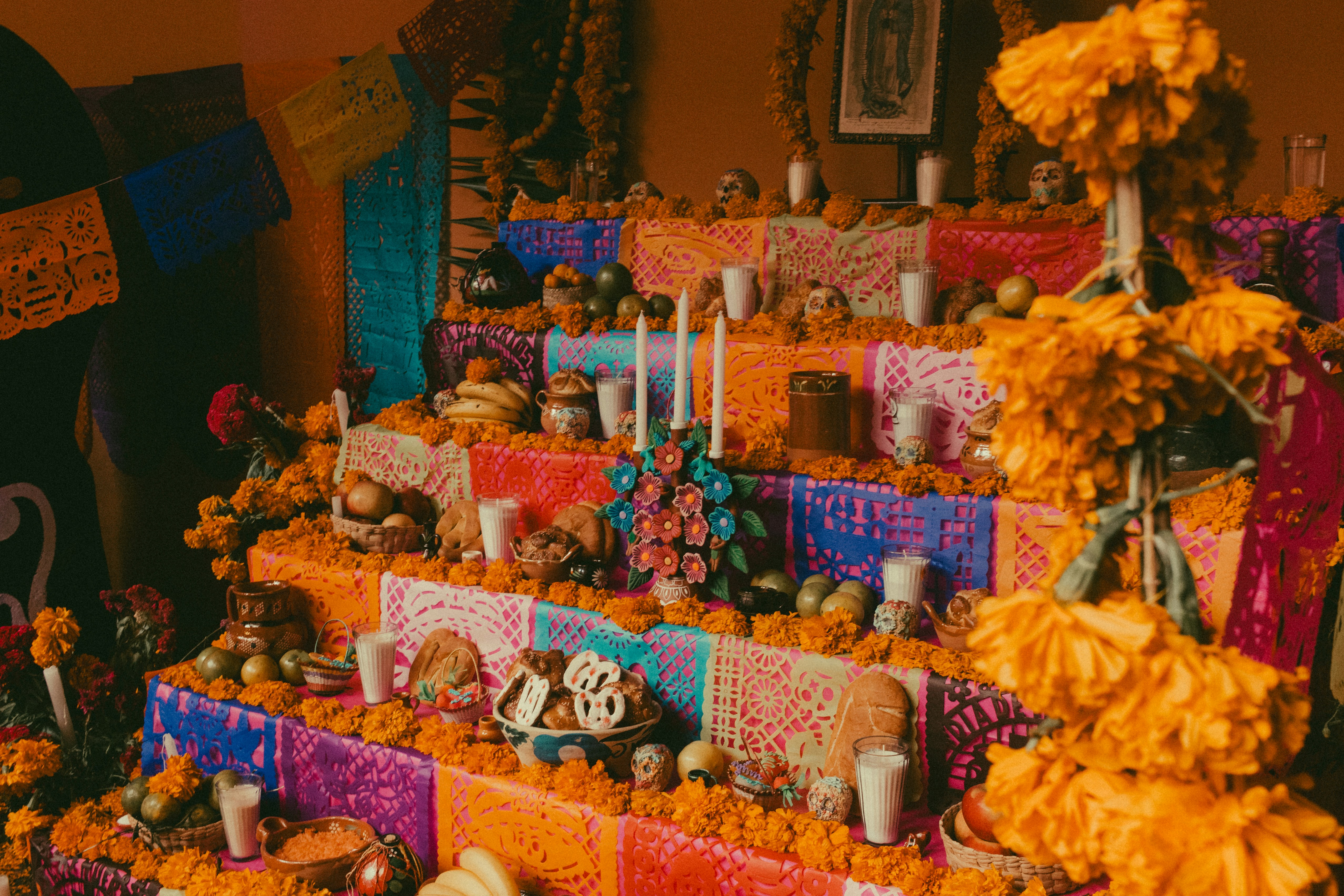 Día de los Muertos ofrenda with marigolds, pan de muerto, and papel picado in Puebla, Mexico
